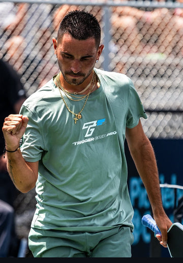 Pro pickleball player Gabe Joseph celebrating on court wearing TriggerGrip Pro, trusted for control, power, and elbow and wrist relief