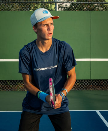 Pro pickleball player Jason Bruce wearing TriggerGrip Pro, enhancing paddle control, power, and providing elbow and wrist relief