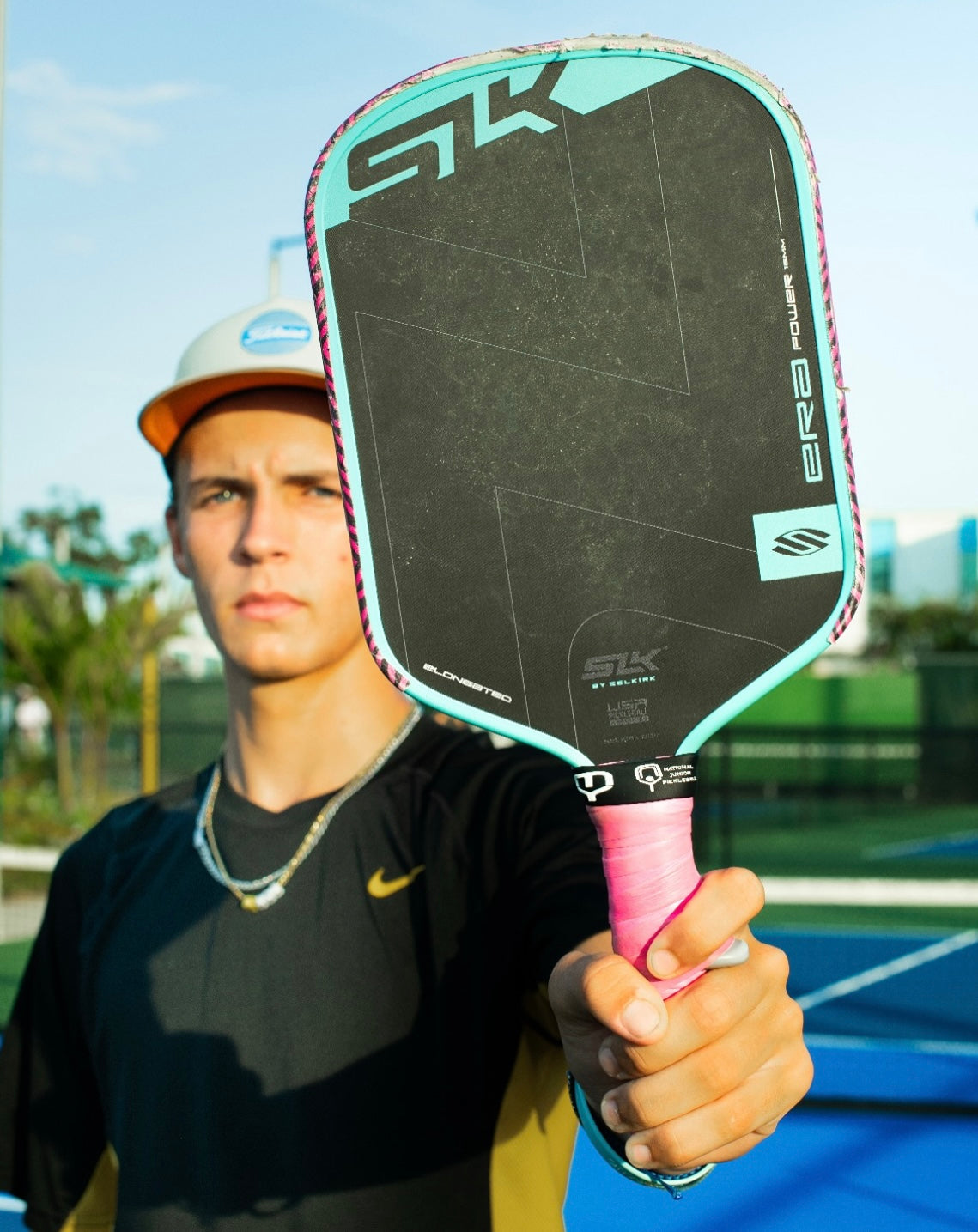 Pickleball pro player holding Selkirk ERA paddle with TriggerGrip Pro for better control and power on the court