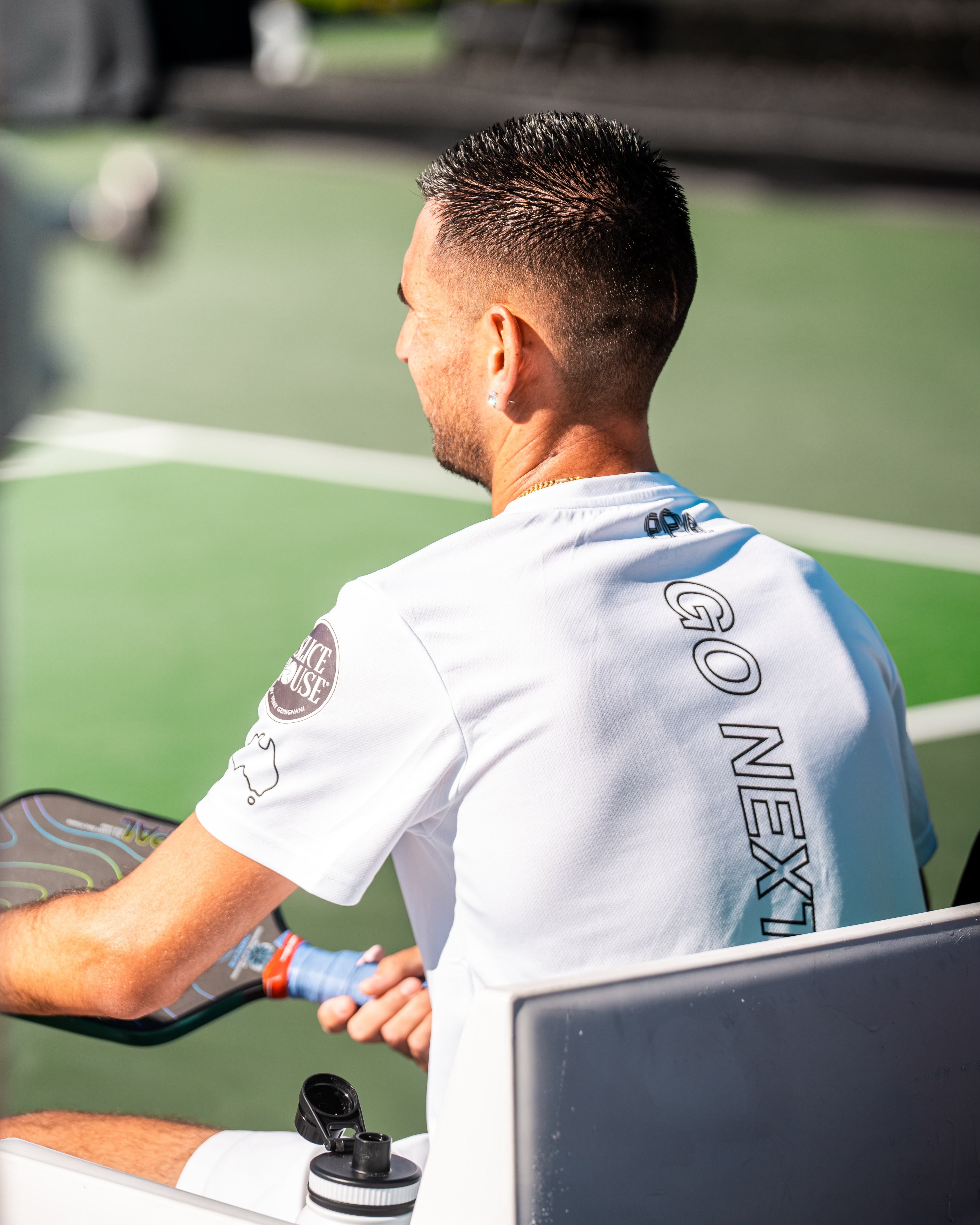 TriggerGrip Pro pickleball grip insert sponsored pro Gabe Joseph courtside holding a paddle between points during a tournament