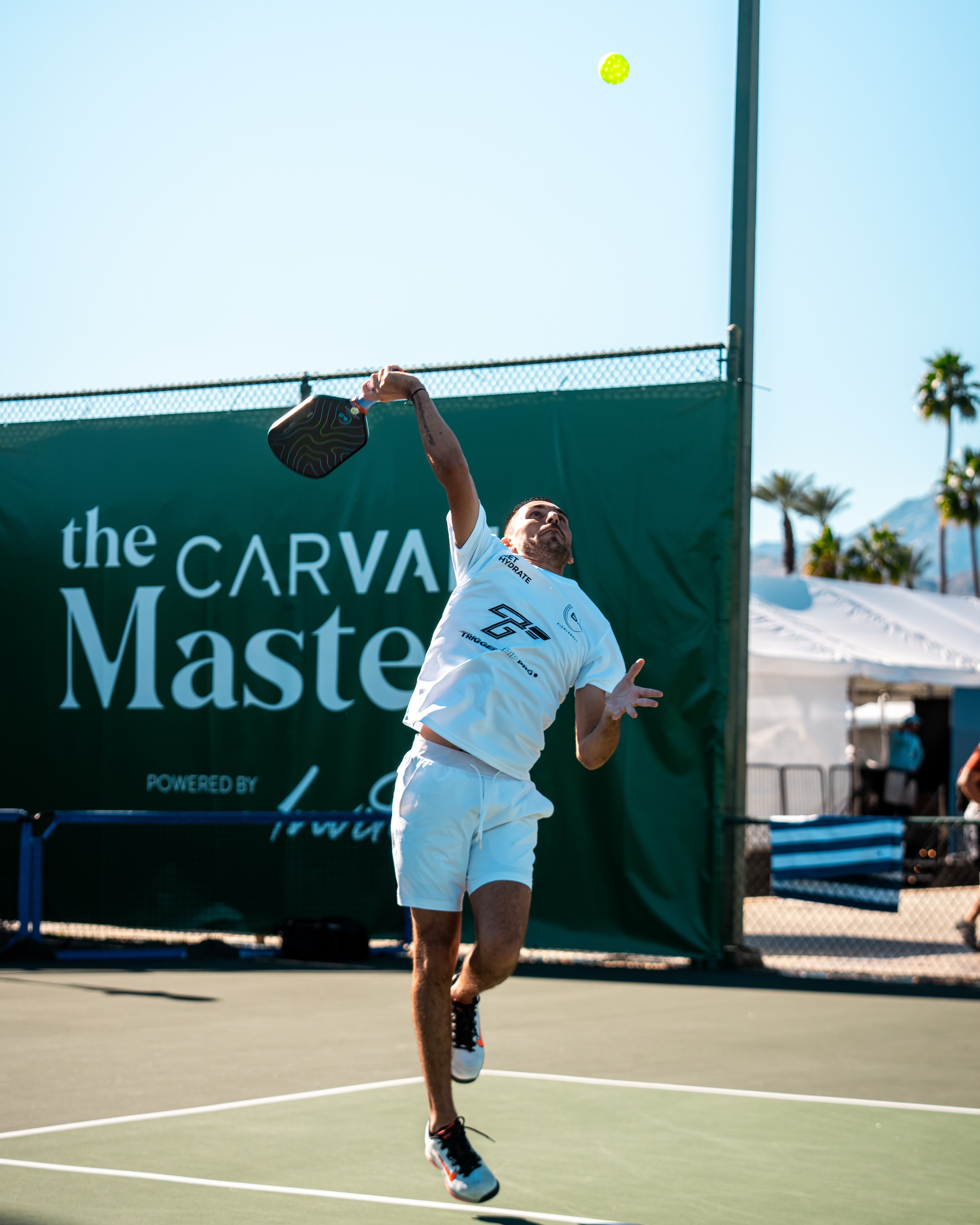 TriggerGrip Pro pickleball grip insert sponsored pro Gabe Joseph jumping for an overhead smash at the Carvana Masters tournament