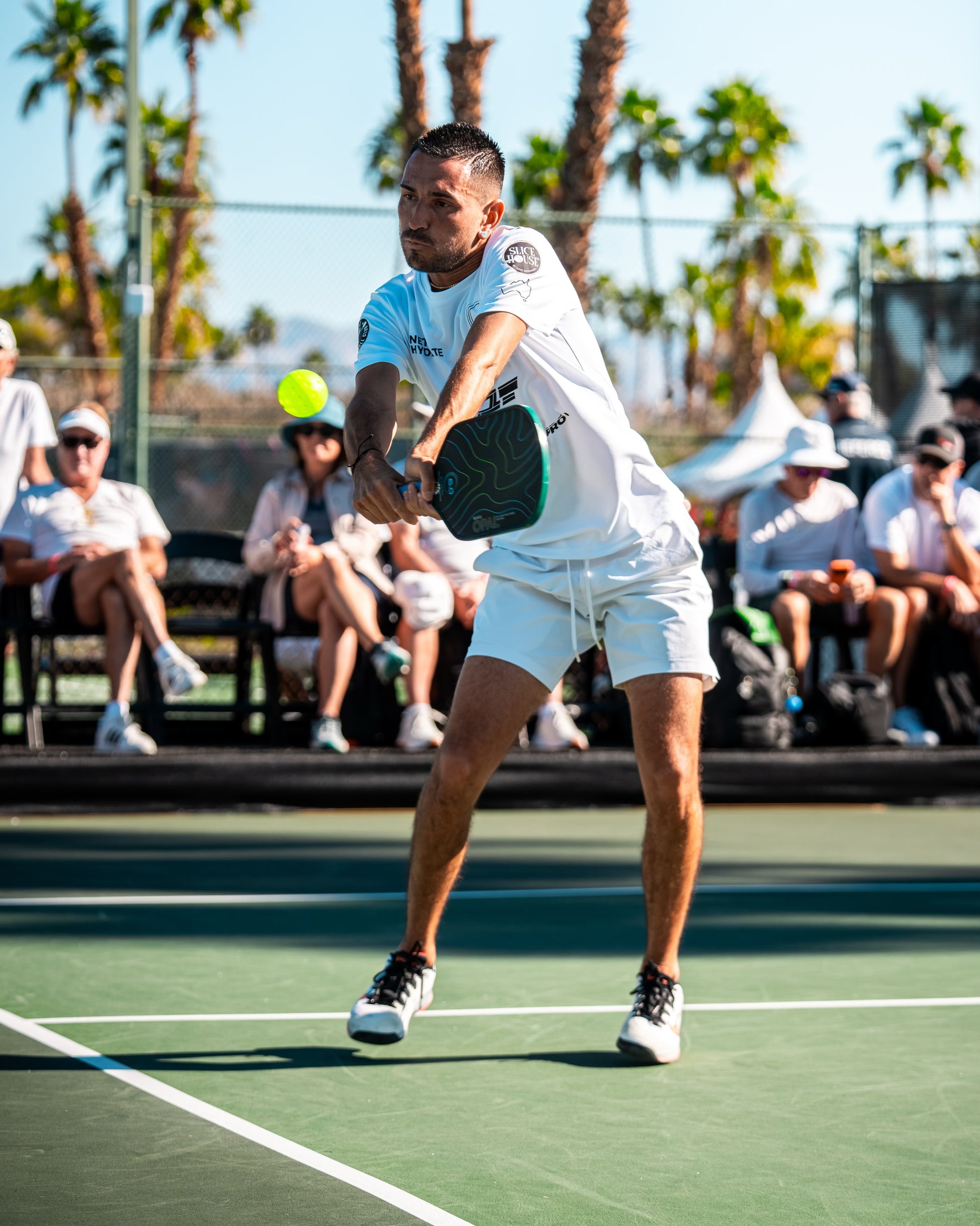 TriggerGrip Pro pickleball grip insert sponsored player Gabe Joseph hitting a two-handed backhand in a professional pickleball match