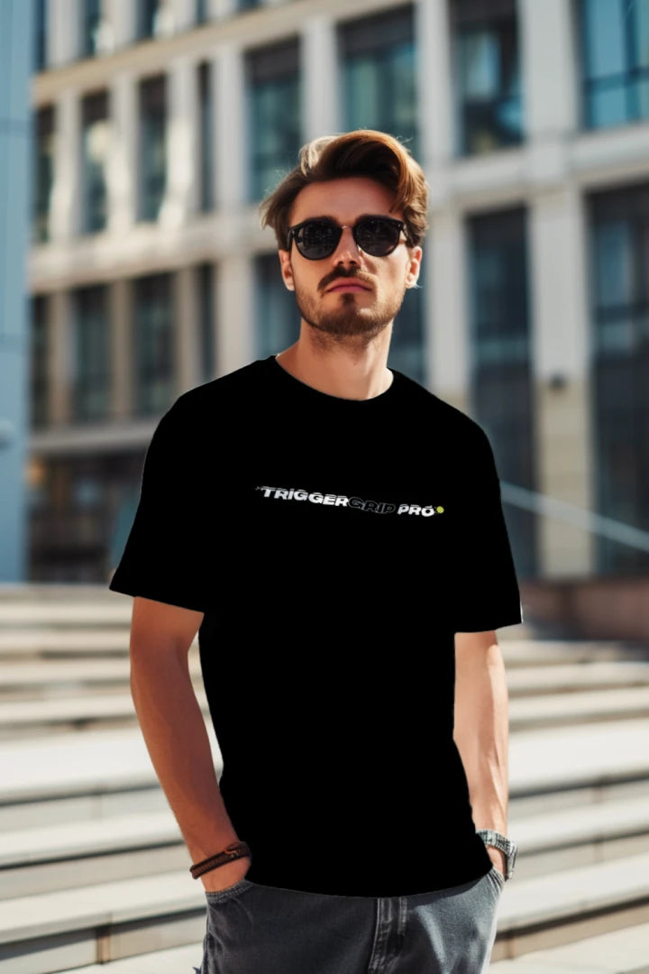 Man wearing black TriggerGrip Pro pickleball shirt with wordmark logo outdoors